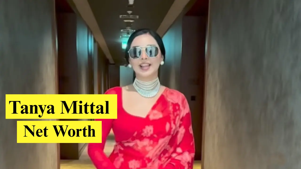 Woman in red saree, hallway setting.